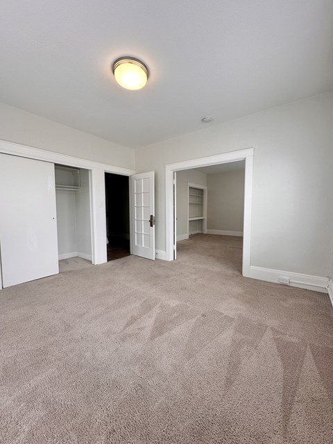 A room with carpeted floor and white walls.