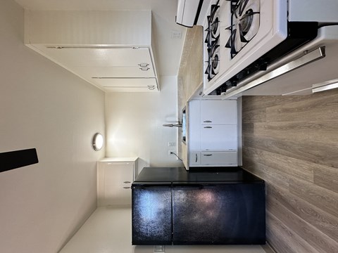 A kitchen with a stove and a refrigerator.