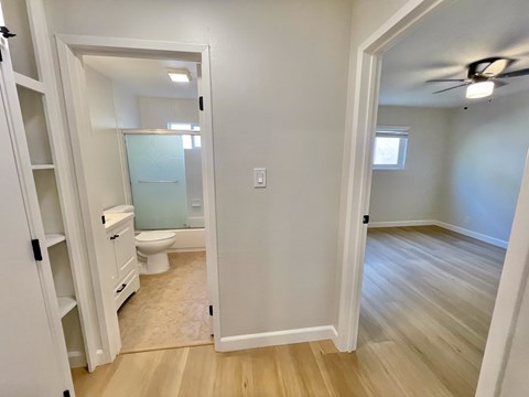 A small bathroom with a toilet, sink, and a mirror.