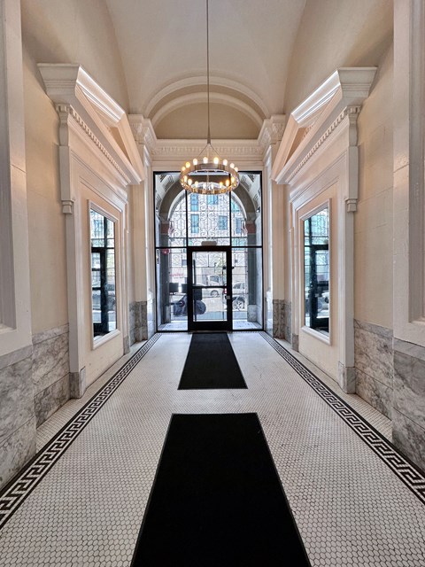 a large hallway with a chandelier and large windows