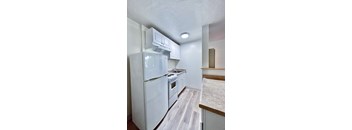 a kitchen with white appliances and white cabinets