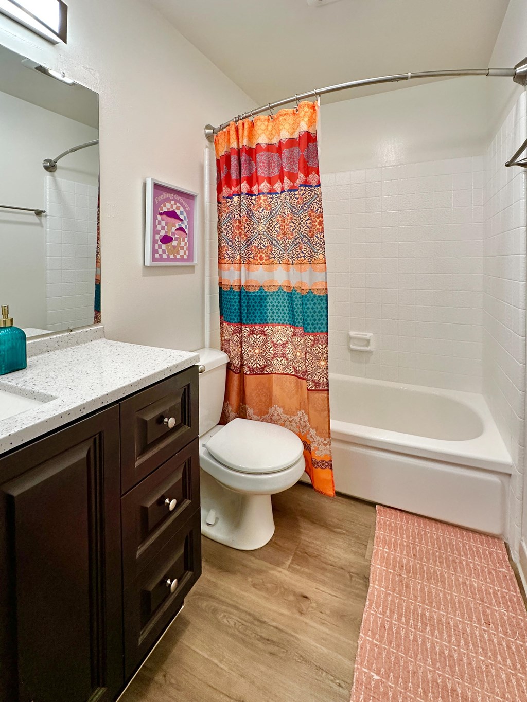 a bathroom with a toilet and a tub and a sink