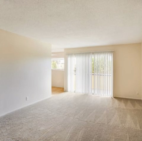 an empty living room with a sliding glass door