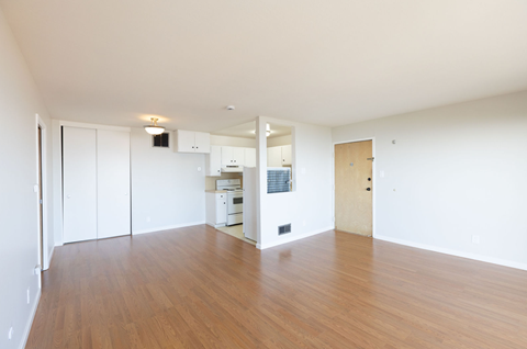 A room with wooden floors and white walls.