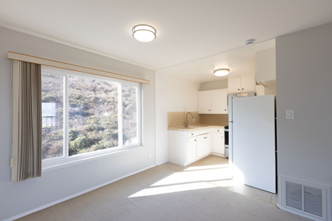 A sunny kitchen with a view of the outdoors.