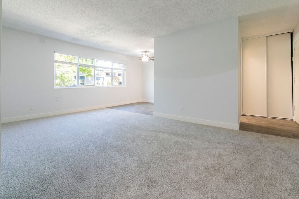 an empty room with white walls and a concrete floor