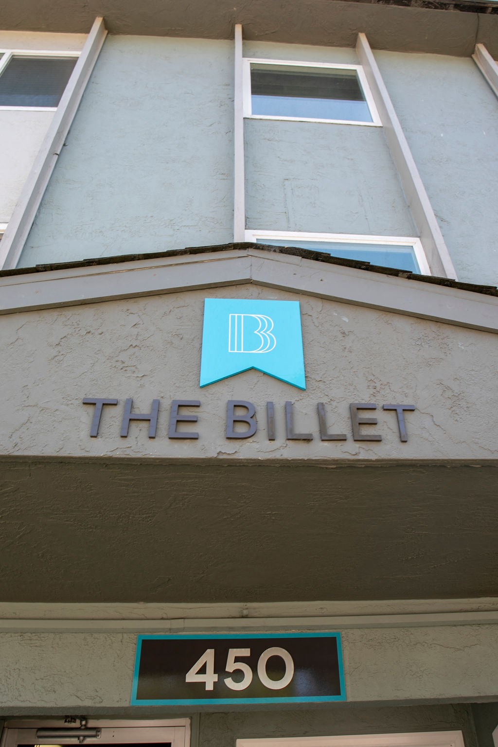 a close up of a building with a blue logo on it
