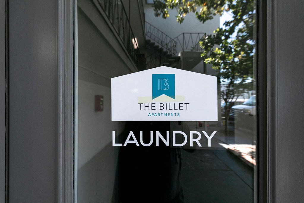 a window with the bidder laundromat logo on it