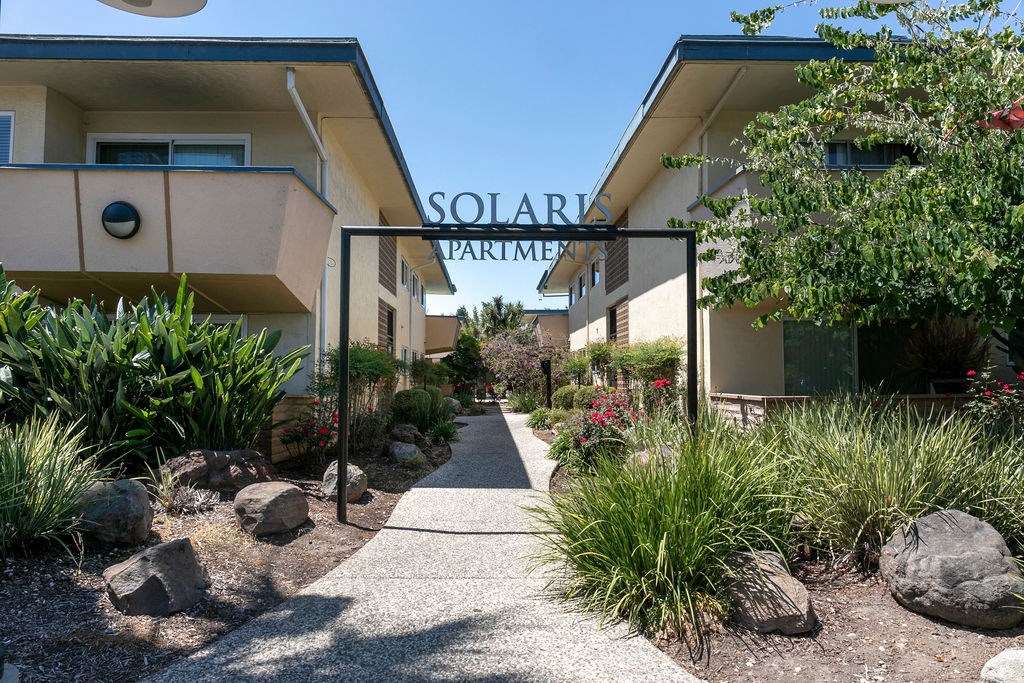 a view of the front entrance to the solar apartments building