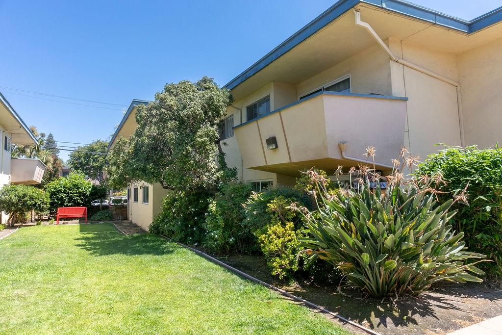 the front yard of a house with a lawn and a garden