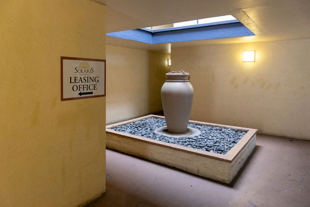 a vase sitting on a ledge in a room with a sign