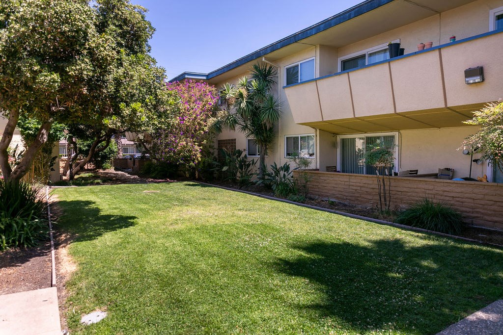 the backyard of a house with a lawn and a fence