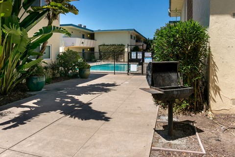 a backyard with a bench and a swimming pool
