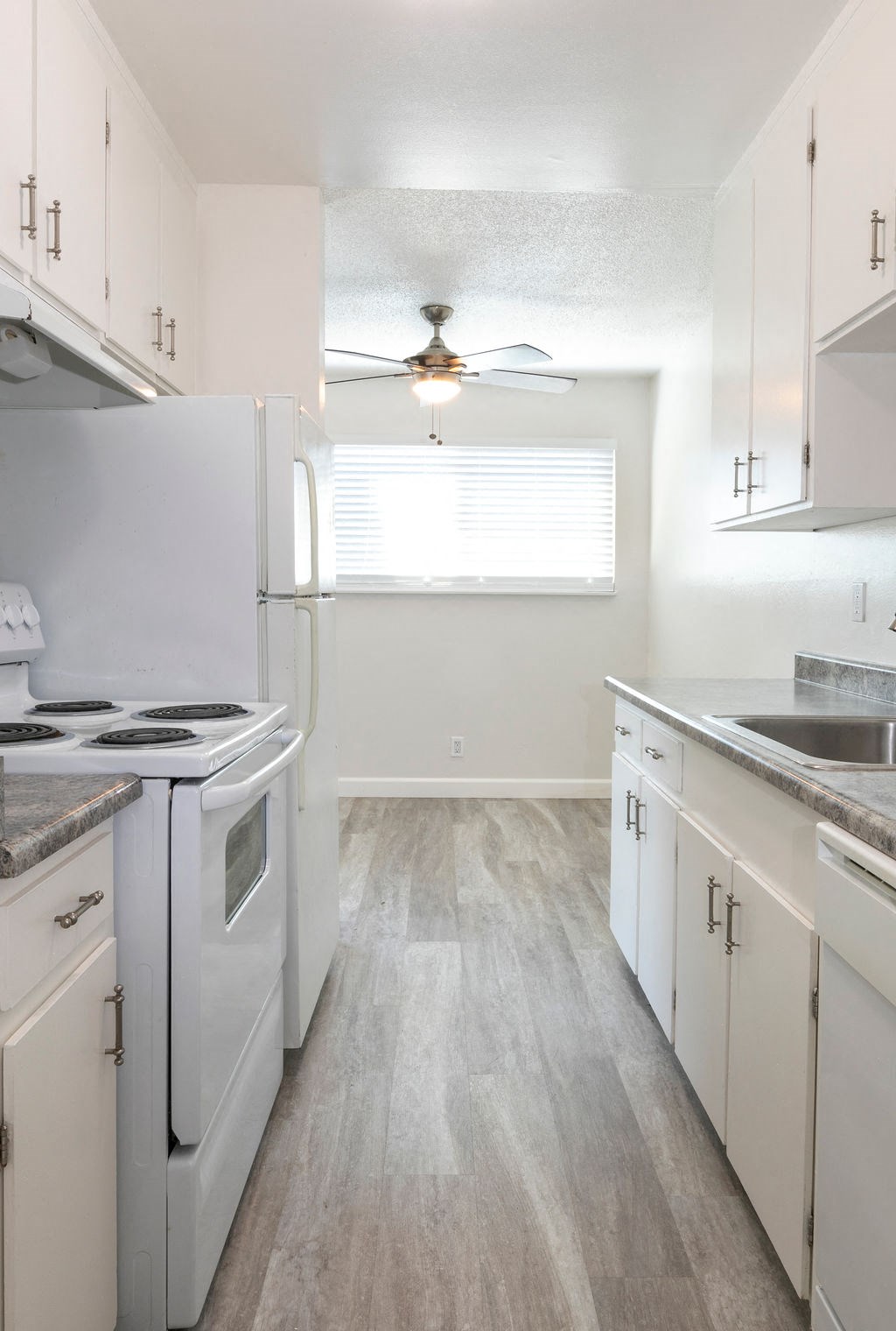 a kitchen with white appliances and white cabinets