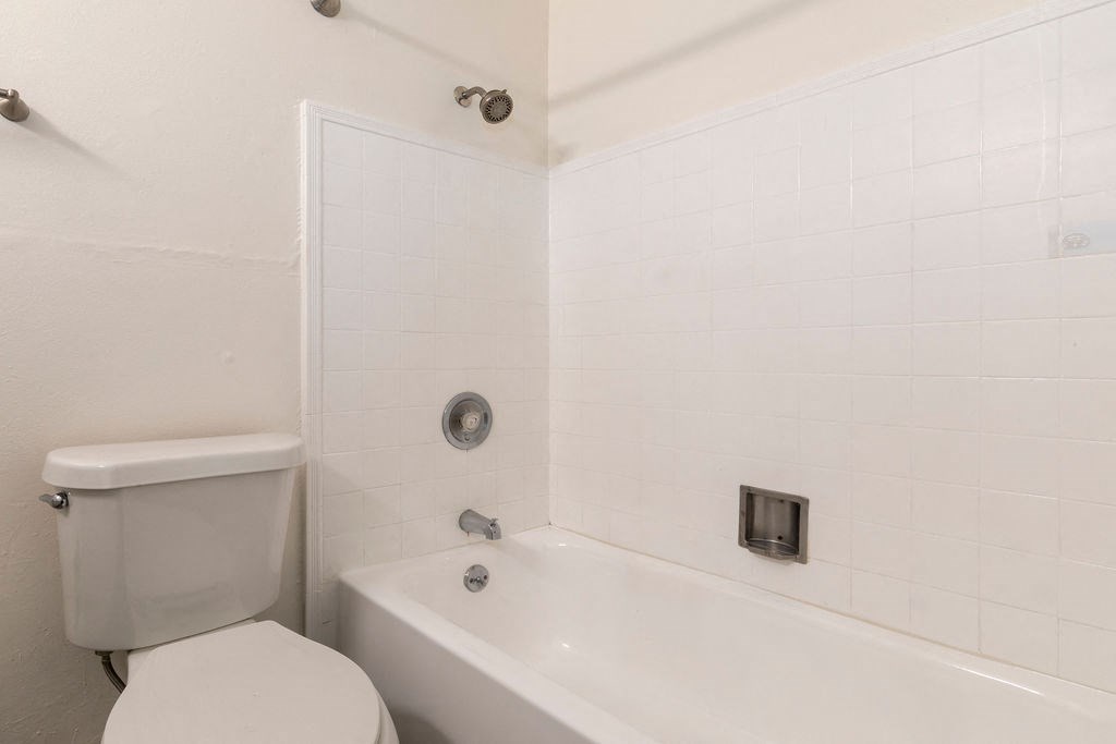 a bathroom with a toilet and a tub