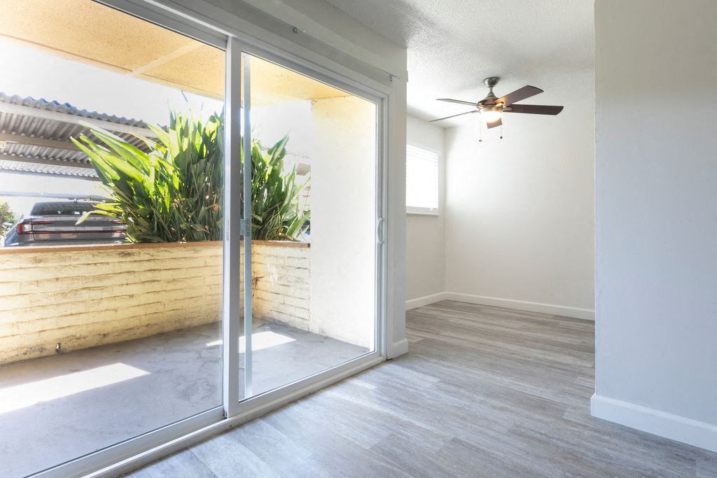 a living room with a sliding glass door and a patio