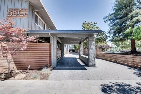 a house with a stone walkway and a wooden fence
