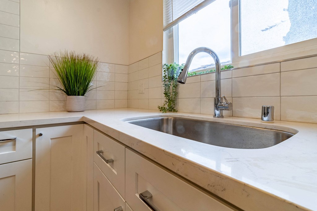 a kitchen with a sink and a window