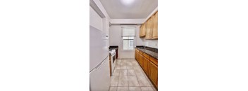 a kitchen with wooden cabinets and a white refrigerator