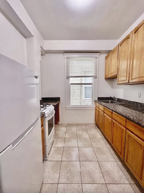 a kitchen with wooden cabinets and a white refrigerator
