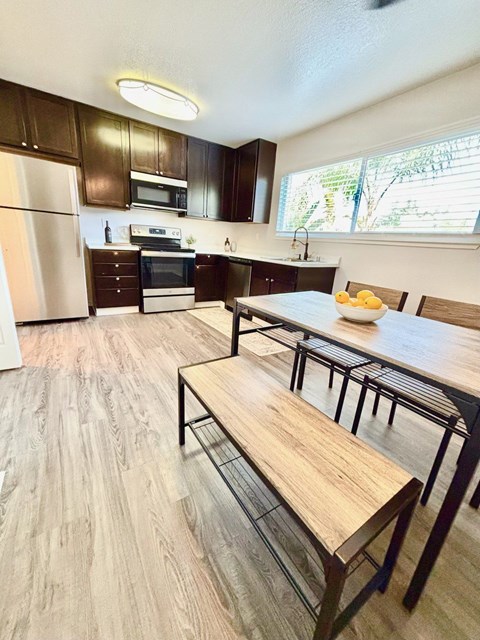 A kitchen with a table and chairs.