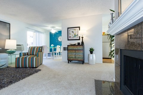 A living room with a fireplace and a chair.