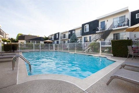 A small pool surrounded by a white fence.