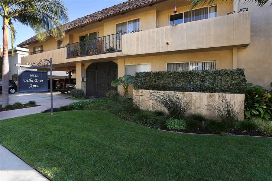 a building with a lawn and a sign in front of it
