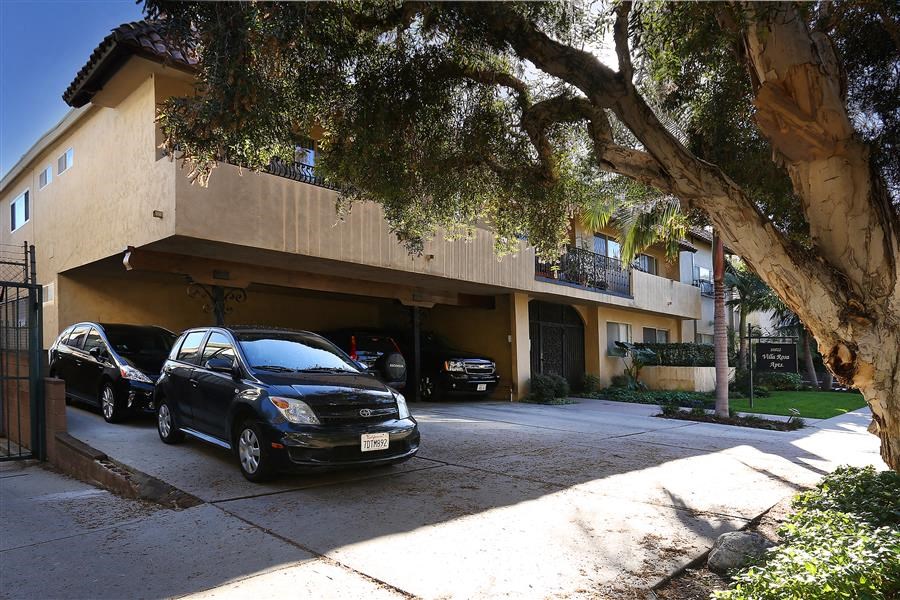 a building with three cars parked in front of it