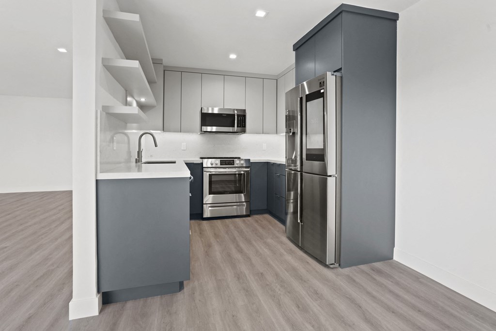 a kitchen with stainless steel appliances and white cabinets
