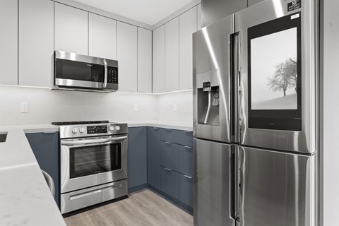 a kitchen with stainless steel appliances and white cabinets