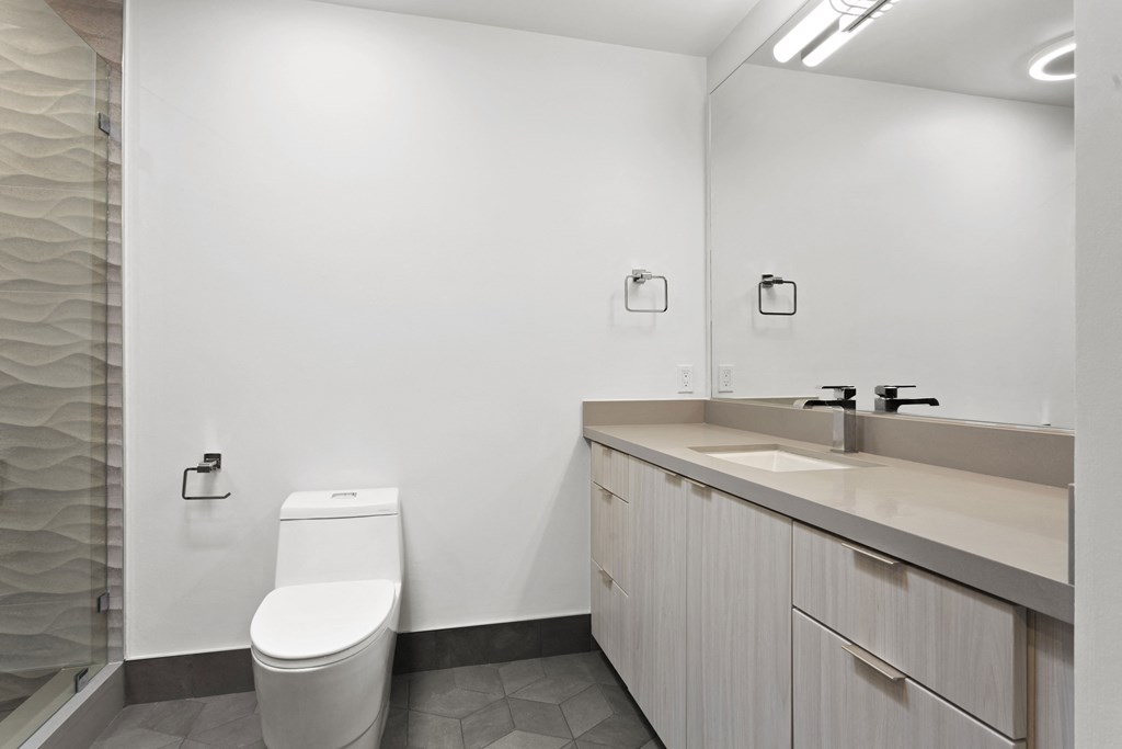 an empty bathroom with a toilet and a sink