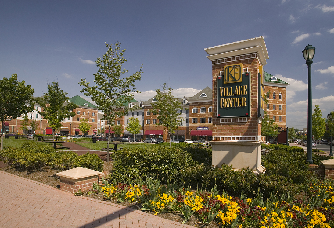 a garden in front of a building with a sign for the mall of the ozarks