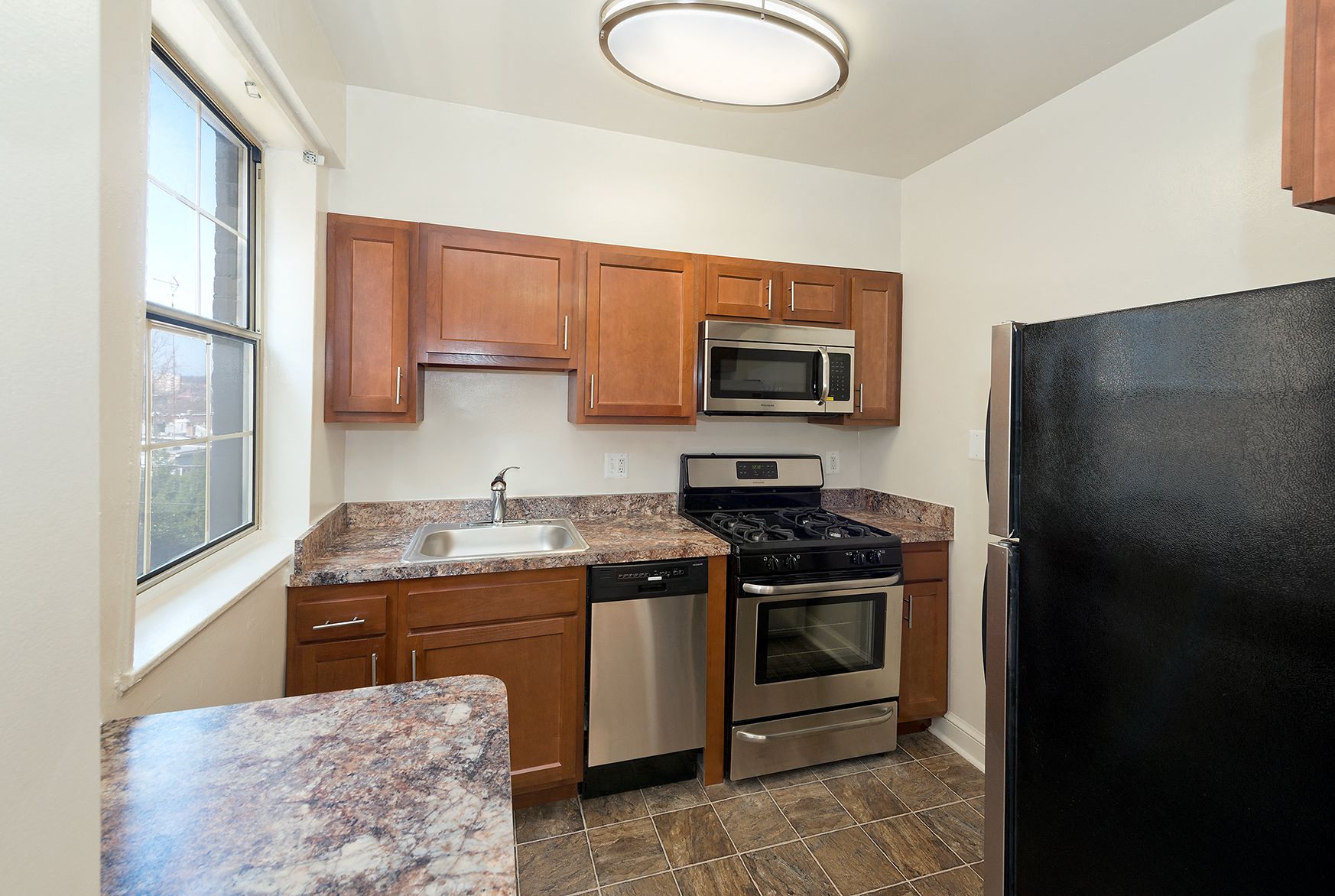 a kitchen with stainless steel appliances and granite counter tops