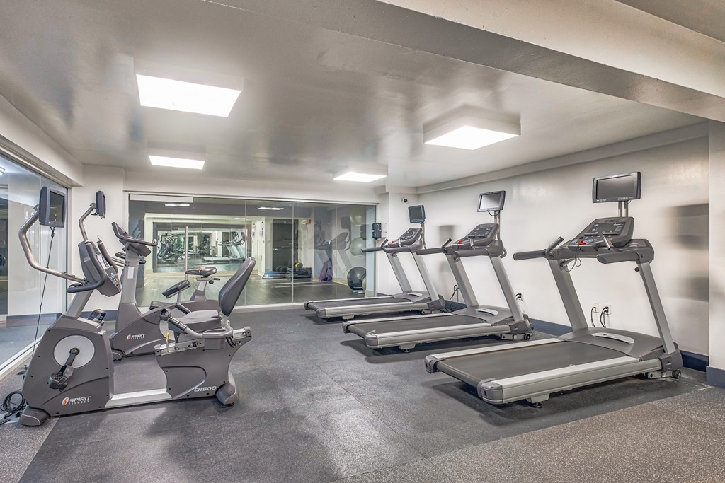 a gym with treadmills and other exercise equipment a gym with treadmills and other exercise equipment at The Argonne Apartments, Washington, Washington DC