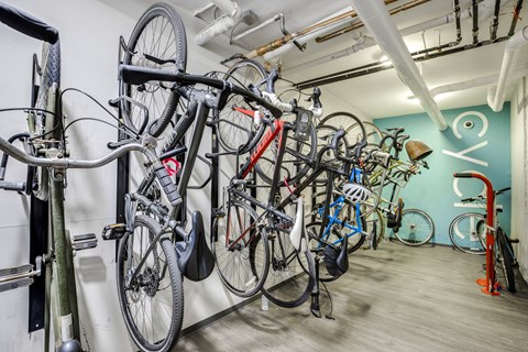 A bike rack with many bikes hanging on it.