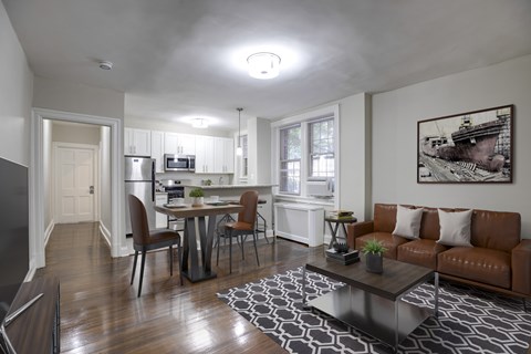 A modern living room with a brown couch and a coffee table.