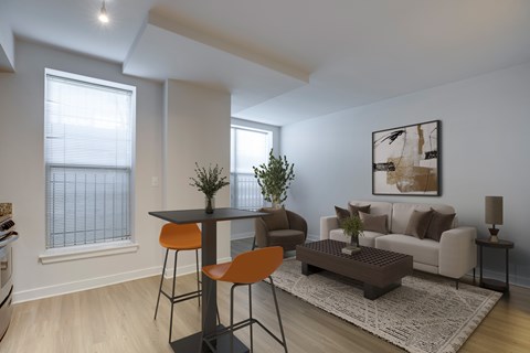 A modern living room with a dining area and a couch.