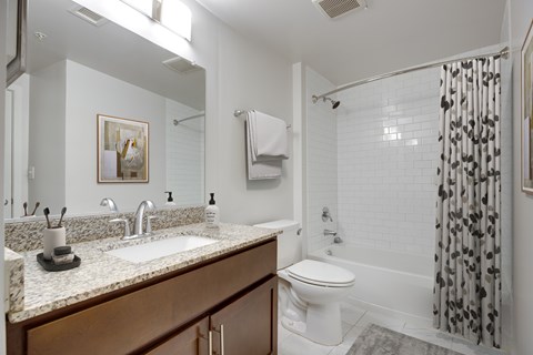 A white toilet sits next to a sink in a bathroom.