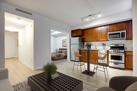 A modern kitchen with wooden cabinets and stainless steel appliances.