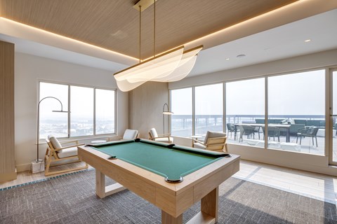 Newly renovated rooftop resident lounge with pool table at Lenox Club Apartments in National Landing, VA 22202