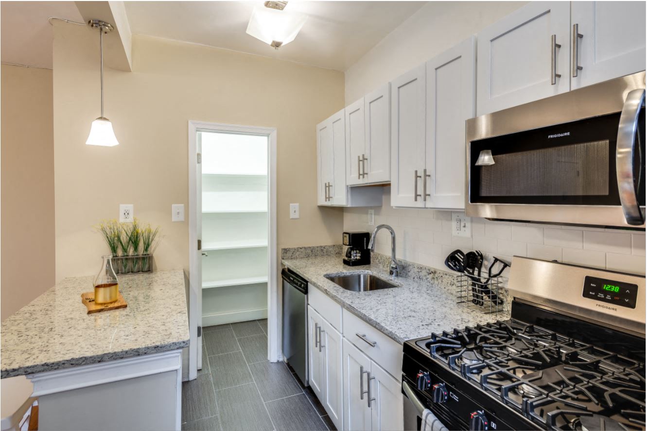 Renovated kitchen with stainless steel appliances and granite countertops  at Kew Gardens, Washington, Washington