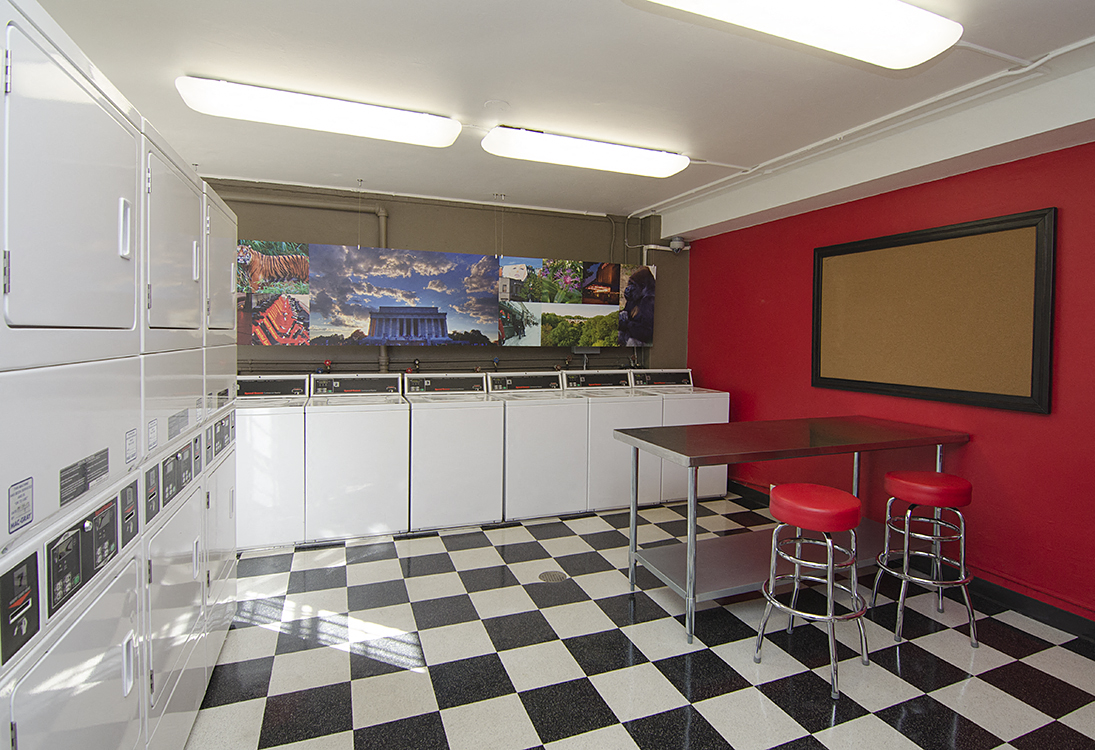 Laundry room with seating area at Cathedral Mansions, Washington, Washington
