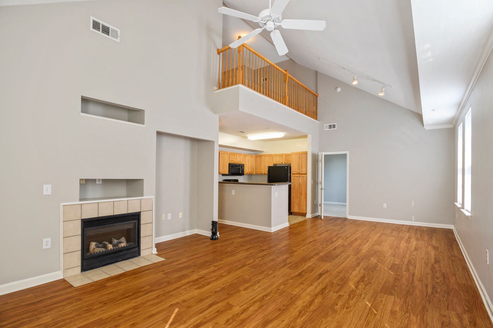 a living room with a fireplace and a ceiling fan