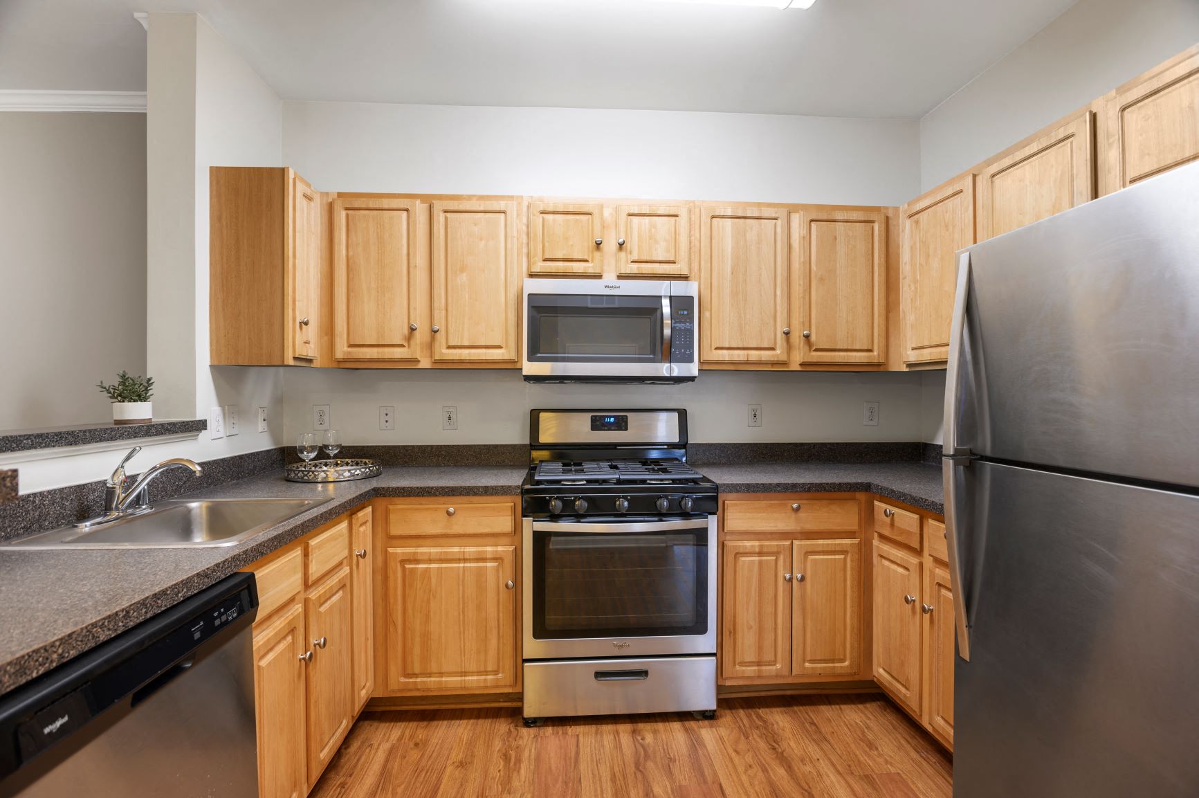 a kitchen with wooden cabinets and stainless steel appliances