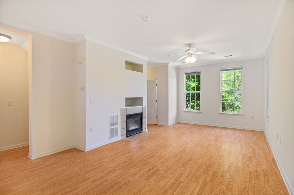a living room with a fireplace and a wooden floor