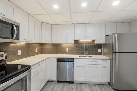 Renovated kitchen with stainless steel appliances  at Lenox Club, Virginia, 22202