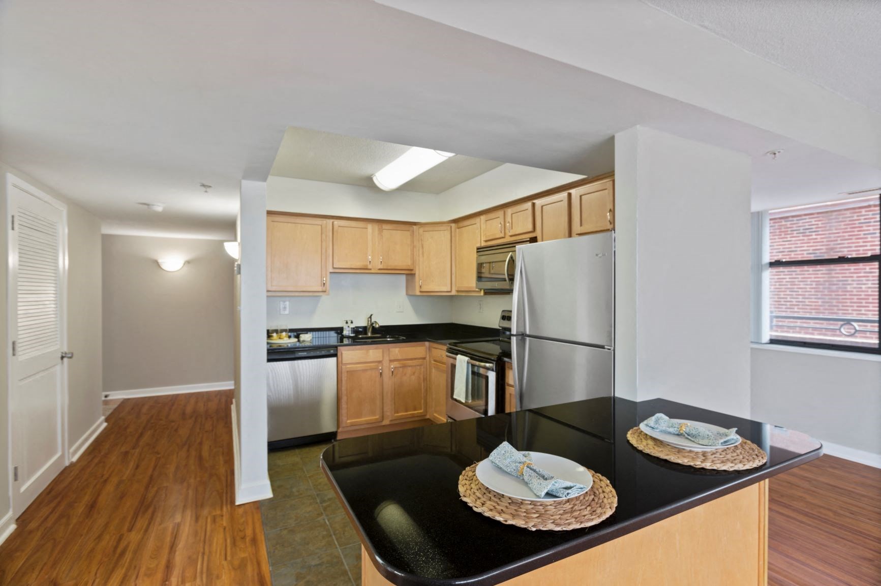 a kitchen with wooden cabinets and stainless steel appliances