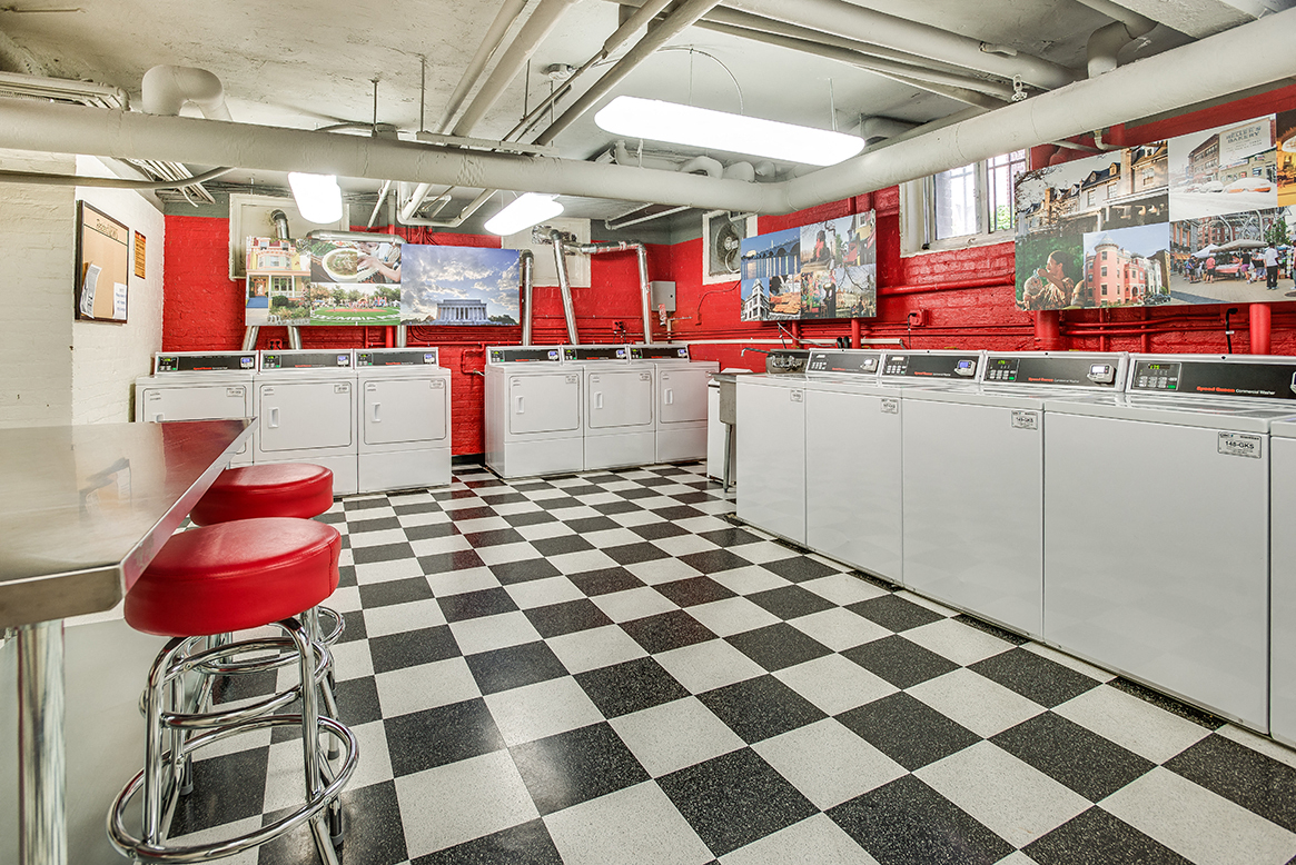 Laundry room with seating area at Highview and Castle Manor, Washington, DC
