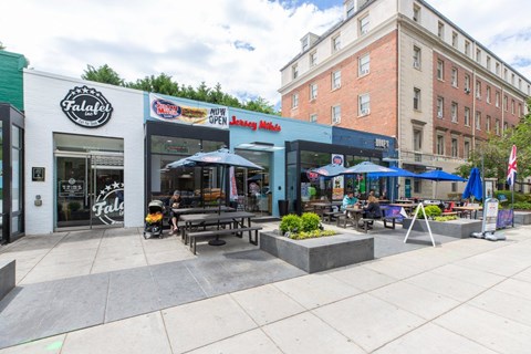 A street view of a restaurant named Falafel with a sign that says